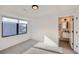 Bright bedroom features gray carpet, a large window, and attached bathroom at 3829 Osage St, Denver, CO 80211