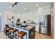 Contemporary kitchen features an island with seating, stainless steel appliances, and modern white cabinetry at 3829 Osage St, Denver, CO 80211