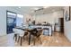 Modern kitchen with sleek white cabinets, stainless steel appliances, an island and a dining area at 3829 Osage St, Denver, CO 80211