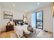 Bright main bedroom featuring wood floors, neutral decor, and glass sliding doors to outside patio at 3829 Osage St, Denver, CO 80211