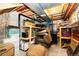 Unfinished basement space with exposed utilities, storage shelves, and an old chair at 11335 Haswell Dr, Parker, CO 80134