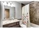 Bathroom sink and shower with decorative tile and floral shower curtain at 11335 Haswell Dr, Parker, CO 80134