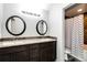 Bathroom with double vanity, granite countertop, and shower with decorative tile at 11335 Haswell Dr, Parker, CO 80134