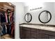 Bathroom with double vanity, granite countertop, and walk-in closet at 11335 Haswell Dr, Parker, CO 80134