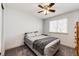 Comfortable bedroom with carpeted floors, ceiling fan, and a large window at 11335 Haswell Dr, Parker, CO 80134