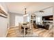 Inviting dining area with wood floors, chandelier, and open floor plan to the living room at 11335 Haswell Dr, Parker, CO 80134