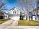 Charming two-story home with a well-maintained front yard and a two-car garage on a sunny day at 11335 Haswell Dr, Parker, CO 80134