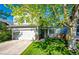 Inviting two-story home with lush green lawn, mature trees, and a convenient two-car attached garage at 11335 Haswell Dr, Parker, CO 80134