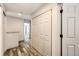Upstairs hallway with wood floors, linen closet, and neutral walls at 11335 Haswell Dr, Parker, CO 80134
