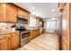 Well-lit kitchen with stainless steel appliances, granite countertops, and wood cabinets at 11335 Haswell Dr, Parker, CO 80134