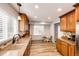 Bright kitchen featuring granite counters, wood cabinets, breakfast nook, and ample natural light at 11335 Haswell Dr, Parker, CO 80134