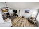 Bright, open living room boasts wood floors, a stone fireplace, and vaulted ceilings at 11335 Haswell Dr, Parker, CO 80134