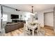 Open-concept living area, adjoining dining space, with a fireplace, hardwood floors, and plenty of natural light at 11335 Haswell Dr, Parker, CO 80134