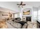 Open-concept living room with fireplace, modern furniture, and seamless flow to the dining area at 11335 Haswell Dr, Parker, CO 80134