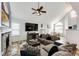 Bright and airy living room with modern decor, a cozy fireplace, and vaulted ceilings at 11335 Haswell Dr, Parker, CO 80134