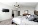 Bright main bedroom featuring a TV, sliding barn door, and neutral gray tones at 11335 Haswell Dr, Parker, CO 80134