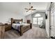 Spacious main bedroom featuring vaulted ceiling, ceiling fan, and rustic wood furniture at 11335 Haswell Dr, Parker, CO 80134