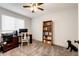 Office space featuring carpeted floors, a ceiling fan, and built-in bookshelves at 11335 Haswell Dr, Parker, CO 80134