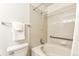 A cozy bathroom with a combination bathtub and shower features tiled walls and a neutral color palette at 5872 W Asbury Pl, Lakewood, CO 80227