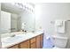 Functional bathroom with double sinks, a large mirror, and a shower-tub combination at 5872 W Asbury Pl, Lakewood, CO 80227