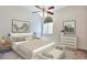 Serene bedroom featuring a ceiling fan, large window, and contemporary decor at 5872 W Asbury Pl, Lakewood, CO 80227