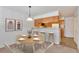 Eat-in kitchen with counter seating, complemented by a dining area featuring modern artwork at 5872 W Asbury Pl, Lakewood, CO 80227