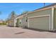 Exterior shot highlighting the townhome's two-car garage, providing convenient parking and storage at 5872 W Asbury Pl, Lakewood, CO 80227