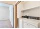 Convenient laundry room with full-size washer and dryer, storage shelf, and easy access at 5872 W Asbury Pl, Lakewood, CO 80227