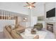 Inviting living room with a cozy fireplace, vaulted ceilings, and neutral decor and lots of light at 5872 W Asbury Pl, Lakewood, CO 80227