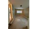 A light-filled bedroom with neutral walls, carpet, and a window with blinds at 1364 Iola St, Aurora, CO 80010