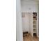 Closet with storage featuring open shelves with wicker baskets and a hanger rod at 1364 Iola St, Aurora, CO 80010