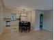 This spacious dining room features hardwood floors, a modern light fixture and access to the kitchen at 1364 Iola St, Aurora, CO 80010