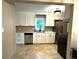 Bright kitchen features white cabinets, stainless appliances and stone countertops at 1364 Iola St, Aurora, CO 80010