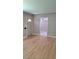 Open-concept living room with hardwood floors, neutral walls and multiple entryways at 1364 Iola St, Aurora, CO 80010