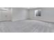Spacious basement featuring neutral walls, carpet, and a window at 3318 N Haleyville Ct, Aurora, CO 80019