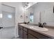 Modern double sink bathroom with custom cabinets and modern lighting at 3318 N Haleyville Ct, Aurora, CO 80019