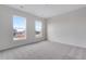 Sun-filled bedroom featuring plush carpet and large picture windows at 3318 N Haleyville Ct, Aurora, CO 80019
