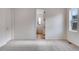 Bright bedroom featuring neutral walls and carpet with an ensuite entrance and natural lighting at 3318 N Haleyville Ct, Aurora, CO 80019