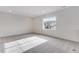 Sun-drenched carpeted bedroom with a large window and neutral paint at 3318 N Haleyville Ct, Aurora, CO 80019