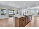Open kitchen with granite island, stainless steel appliances, and view of adjacent living space at 3318 N Haleyville Ct, Aurora, CO 80019