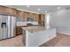 Well-lit kitchen featuring a stainless steel refrigerator, granite countertops, and recessed lighting at 3318 N Haleyville Ct, Aurora, CO 80019