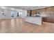 Open-concept living space featuring a modern kitchen island and ample natural light at 3318 N Haleyville Ct, Aurora, CO 80019