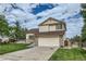 Two story tan house with beige brick siding, a two car garage, and a well maintained lawn at 9544 Josephine St, Thornton, CO 80229