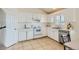 Well-lit kitchen with white cabinetry, stainless steel appliances, neutral tile floors, and plenty of counter space at 9544 Josephine St, Thornton, CO 80229