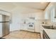 Bright and airy kitchen featuring white cabinets, modern stainless steel appliances, and tiled flooring at 9544 Josephine St, Thornton, CO 80229