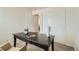 Functional home office featuring a dark desk, sliding closet doors, and neutral decor at 9544 Josephine St, Thornton, CO 80229