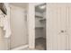 Walk-in closet has shelving next to a glass-door shower at 9544 Josephine St, Thornton, CO 80229
