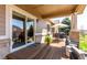 Inviting covered back porch with outdoor seating and dining area, perfect for relaxing or entertaining at 23644 E Phillips Pl, Aurora, CO 80016