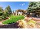 Expansive backyard showcasing lush landscaping, mature trees, and a charming patio area for relaxation and entertainment at 23644 E Phillips Pl, Aurora, CO 80016