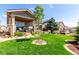 Lush backyard with a well-maintained lawn and manicured landscaping, a perfect setting for outdoor gatherings at 23644 E Phillips Pl, Aurora, CO 80016